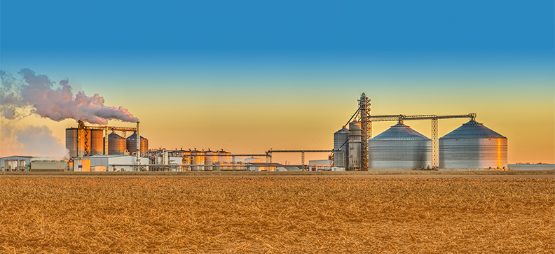ProQuip tank agitators at Ethanol plant in an agricultural landscape. Photo of ProQuip Ethanol Agitators in Fron of Corn Field