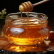 Blog feature image showing honey dripping into a glass bowl